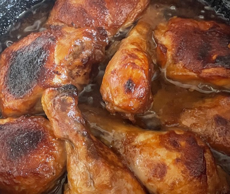 Golden baked chicken coated with chutney and mayonnaise, cooked in dutch oven.