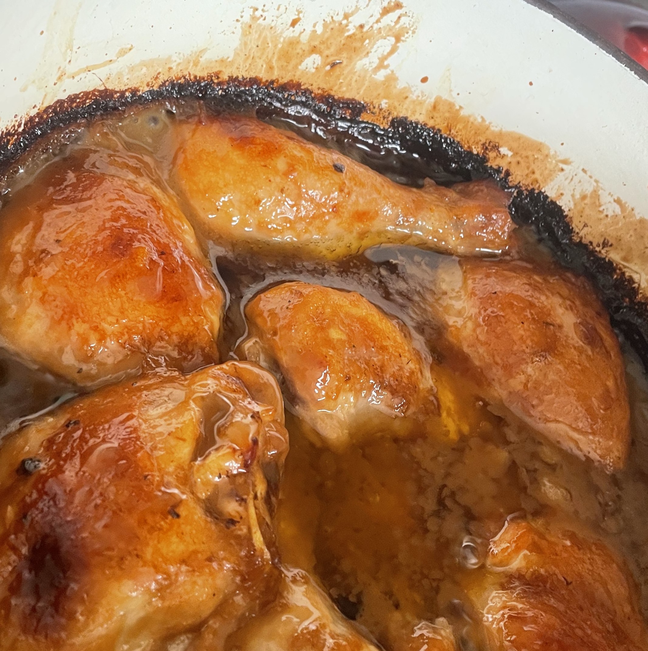 Golden baked chicken coated with chutney and mayonnaise, in a dutch oven